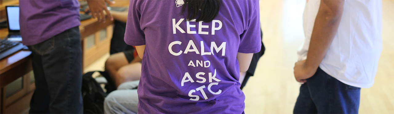 student wearing a purple "keep calm and ask STC" t-shirt