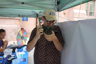 A person checks out a digital camera at an STC event