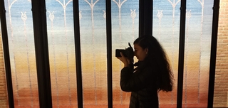 A student takes a photograph using a digital camera